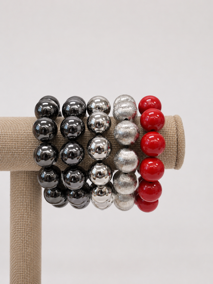 A beaded stretch bracelet made of glossy, round red, black and silver beads. Uga, georgia football, university of Georgia game day jewelry. 