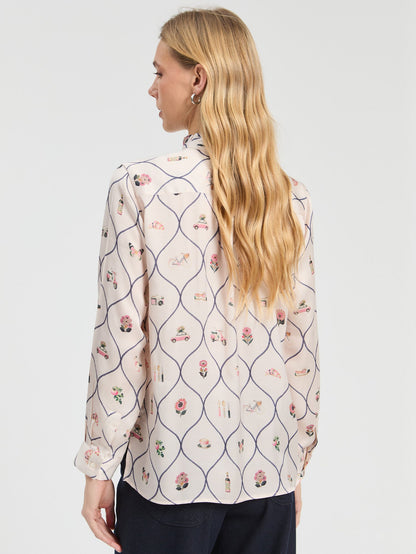 Detail of the illustrated Braserie print on Vilagallo ivory blouse