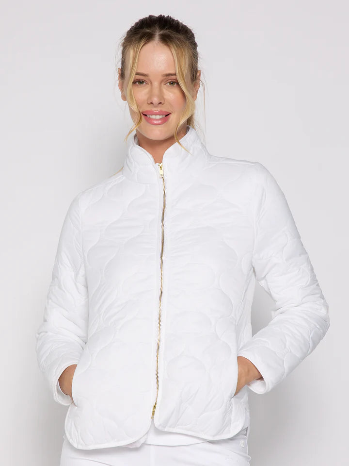 Woman wearing a white quilted jacket on a plain background