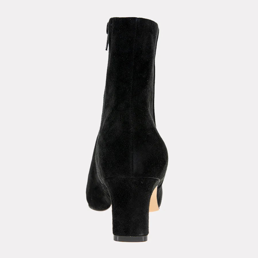 Black suede ankle boot on a light gray background