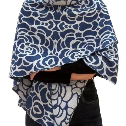 Blue and white patterned fabric draped over a person on a white background