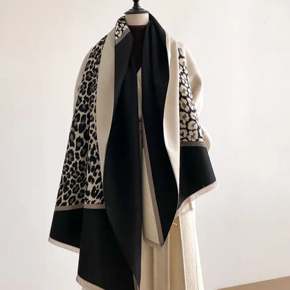 Black and white scarf with cheetah print border on a mannequin against a white background