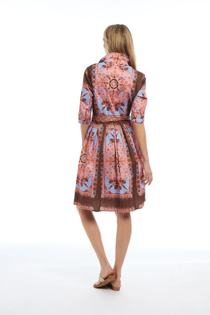 Woman wearing a patterned dress on a white background
