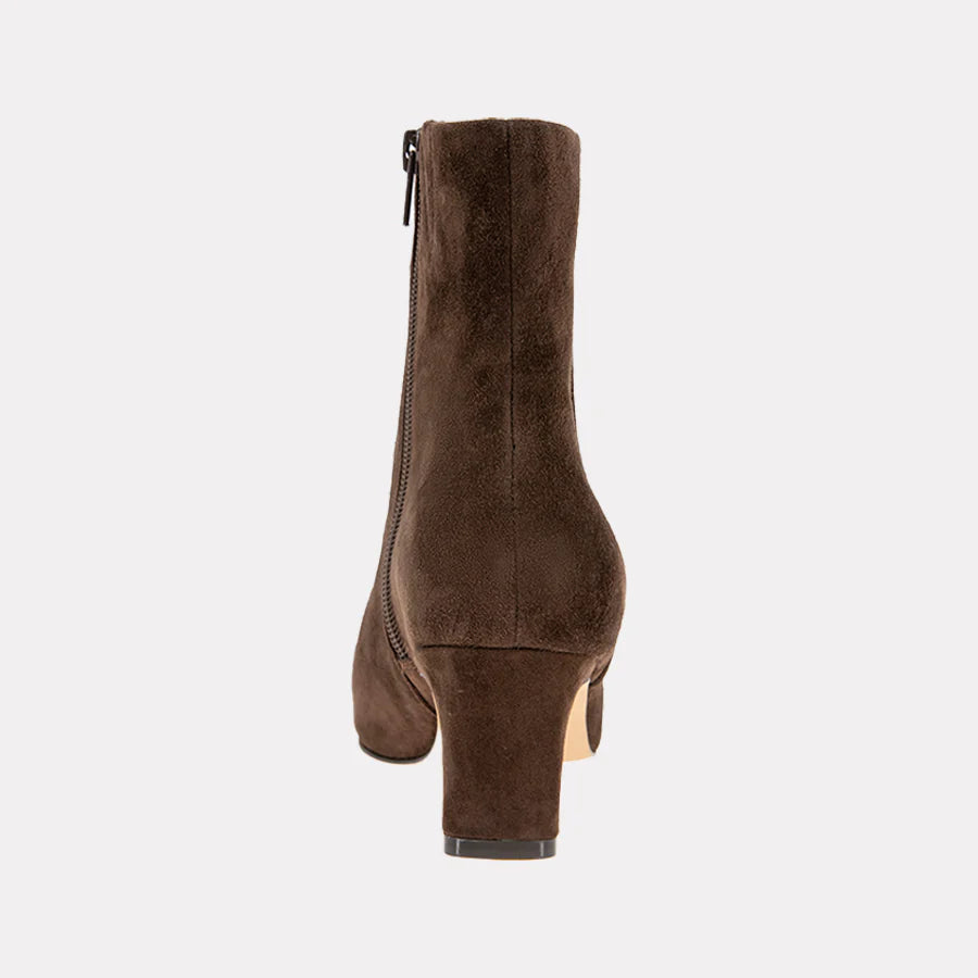 Brown suede ankle boot on a light gray background