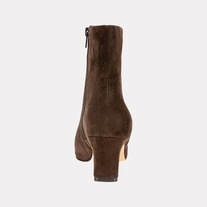 Brown suede ankle boot on a light gray background
