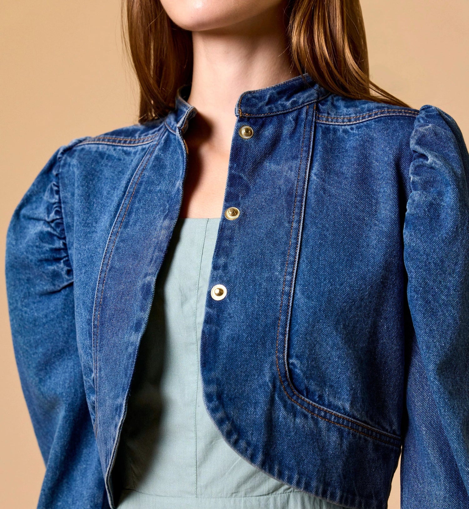 Woman Cleobella | Damien Denim Jacket blue denim jacket over a light green dress on a beige background