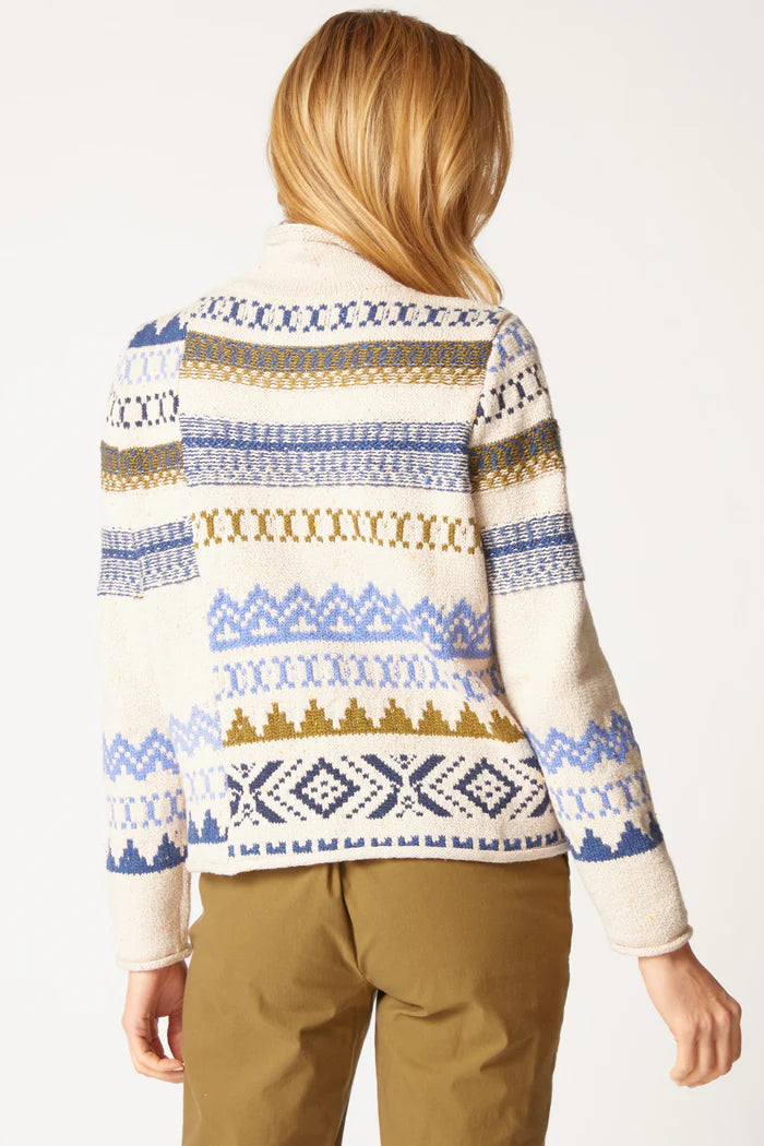 Person wearing a patterned sweater with a white background