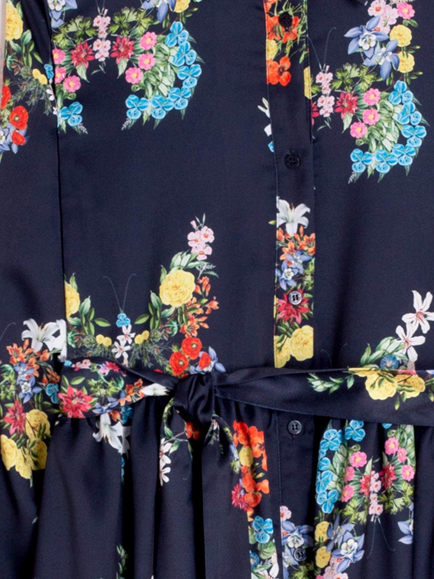Navy blue dress with colorful floral patterns on a dark background
