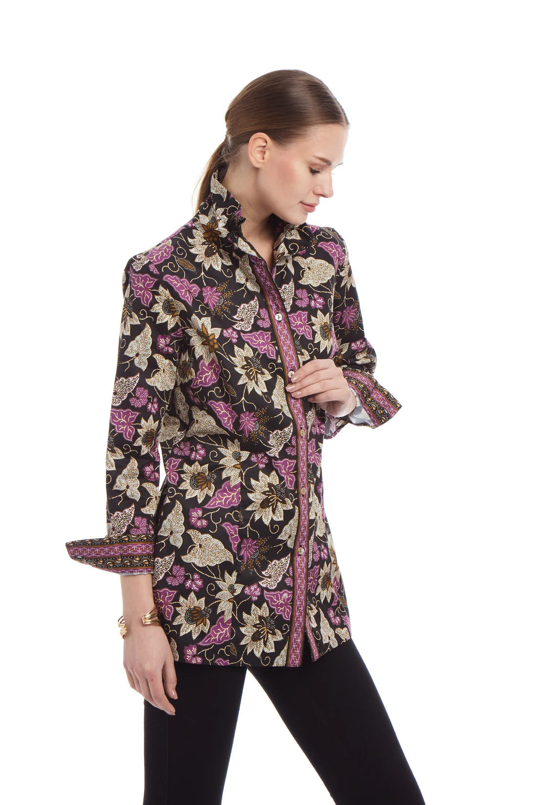 Woman wearing a patterned coat on a white background