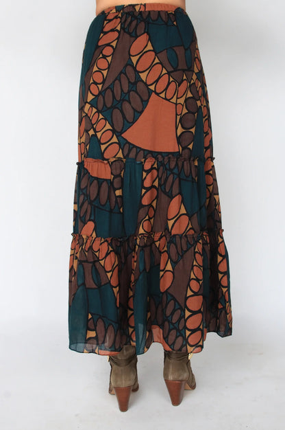 Long patterned skirt with orange and green design on a white background