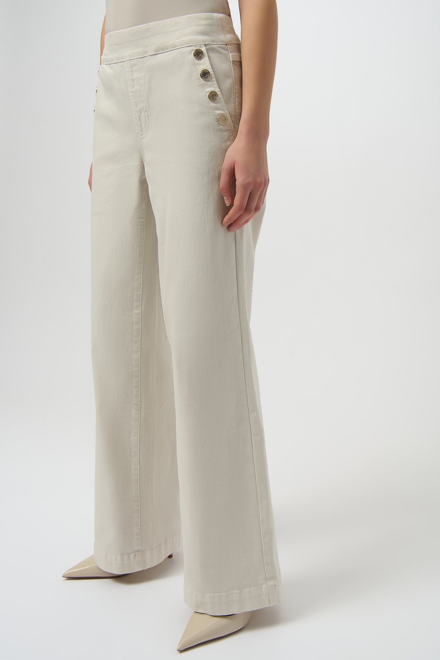 Beige wide-leg pants with button details on a white background