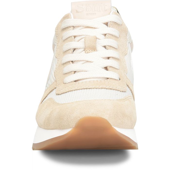 Beige and white sneaker with brown sole on a white background
