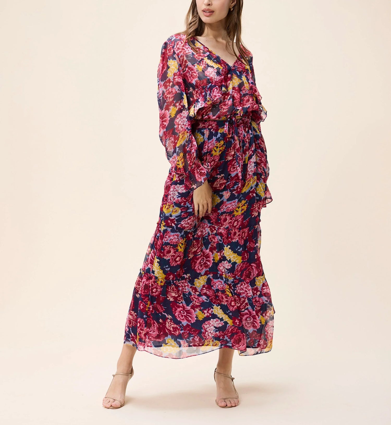 Woman wearing a floral dress on a beige background