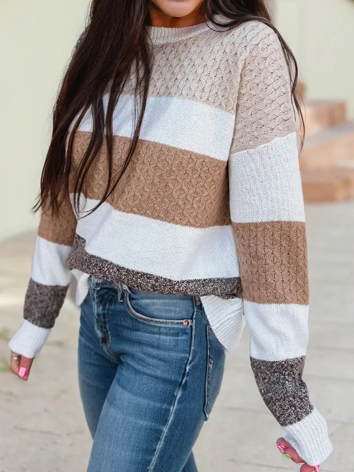 Women in a color block stripped knit sweater in white, light beige, tan, and mocha brown.