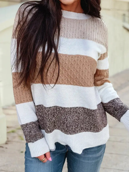 Women in a color block stripped knit sweater in white, light beige, tan, and mocha brown.