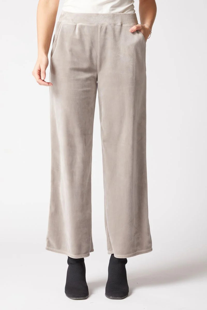 Beige pants worn by a person on a white background