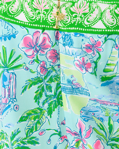 Colorful fabric with floral and nature patterns on a light blue background