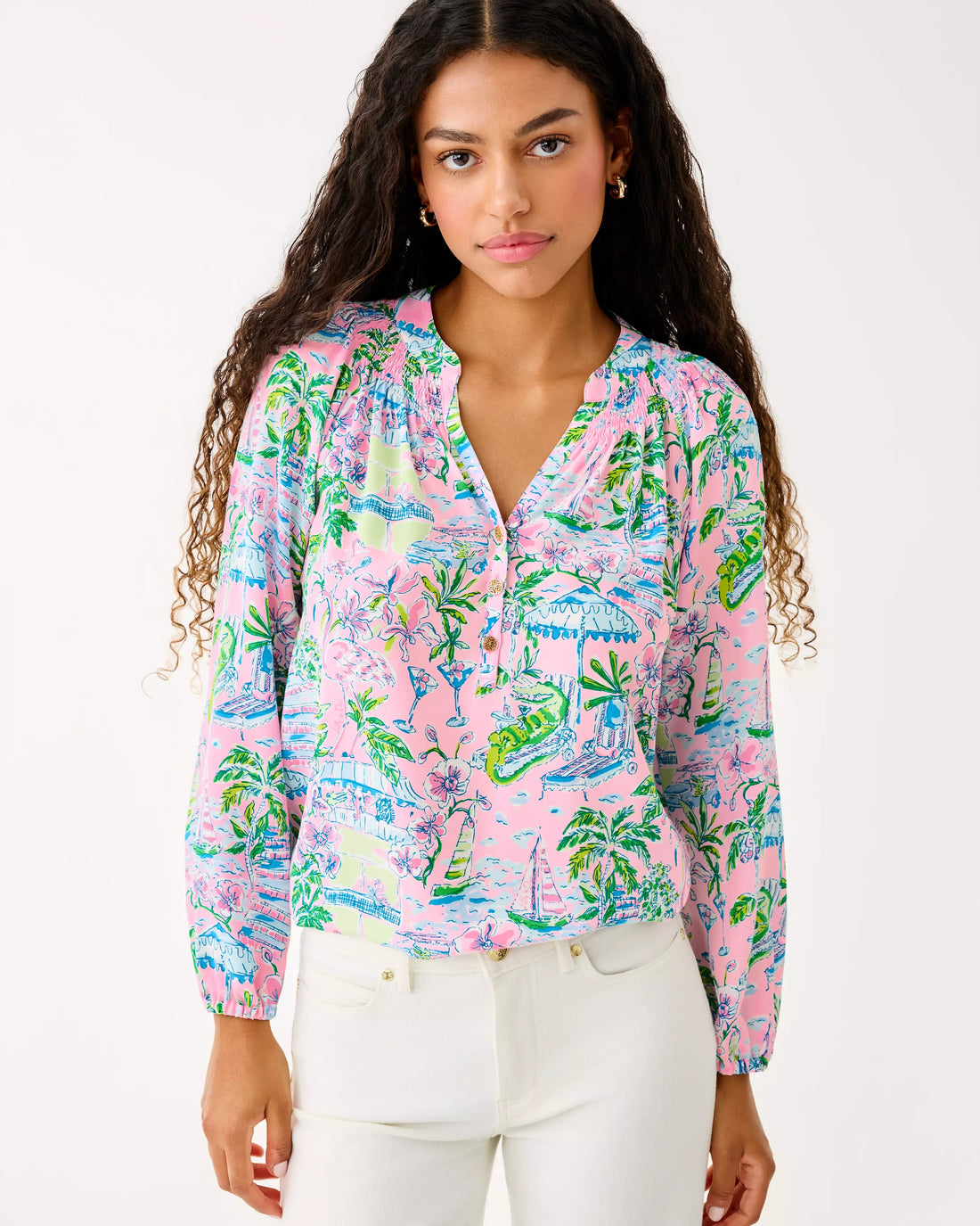 Woman wearing a colorful patterned blouse with a white background