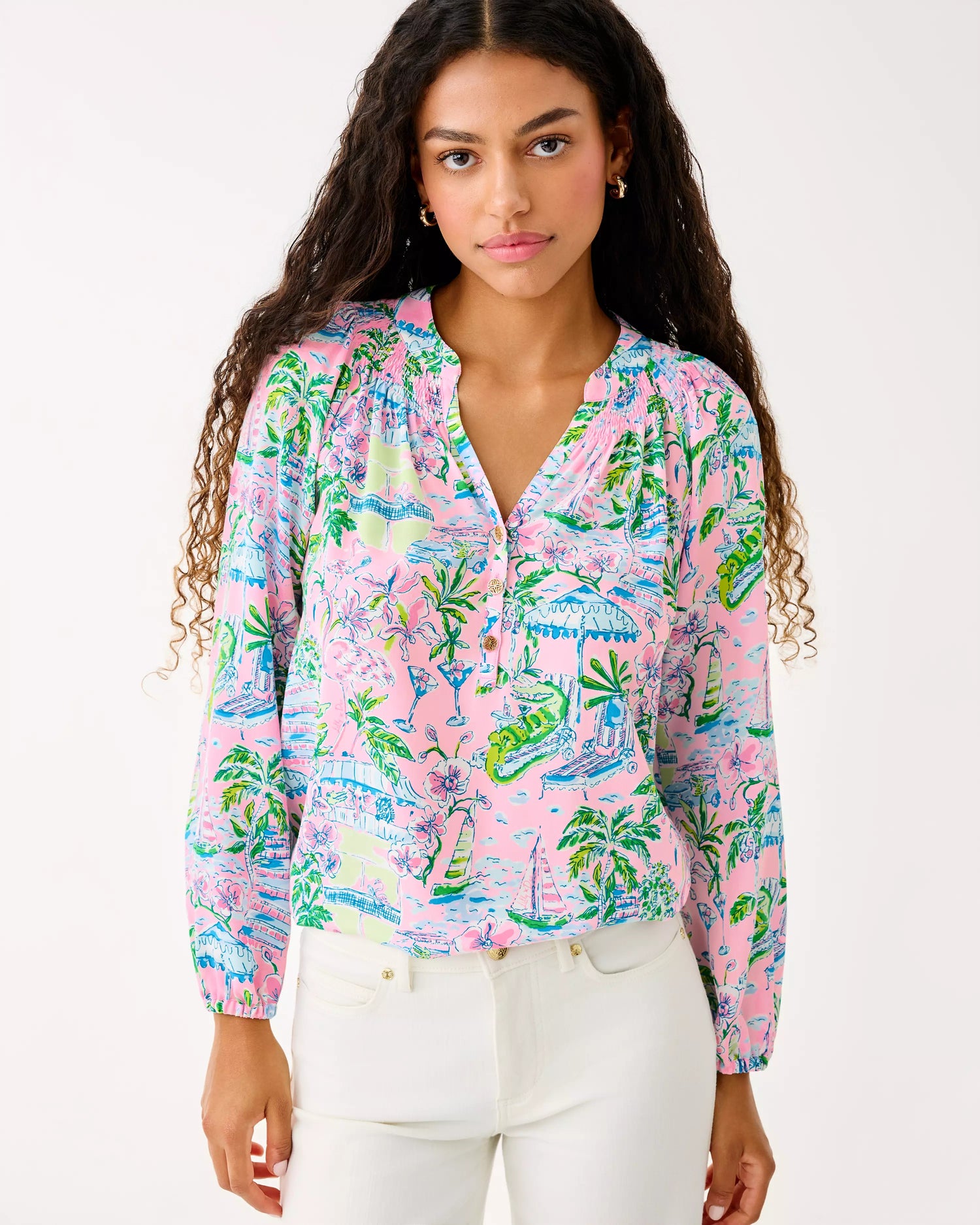 Woman wearing a colorful patterned blouse with a white background