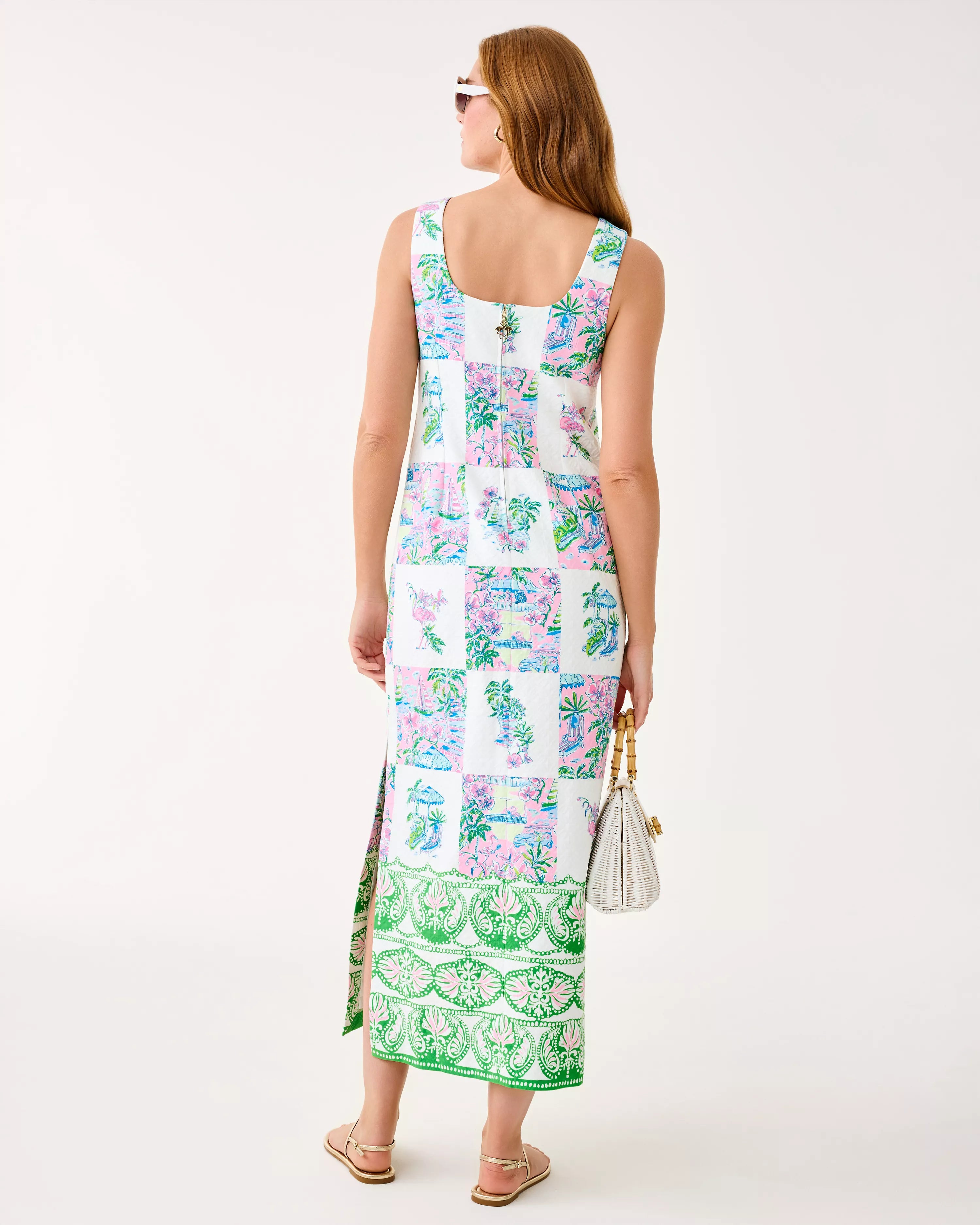 Woman wearing a colorful floral dress with a white background