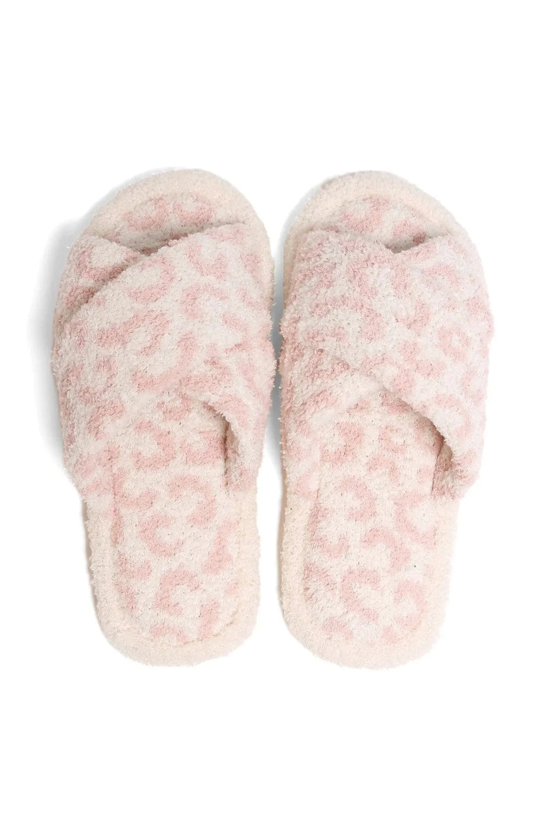 Pair of pink fuzzy slippers on a white background