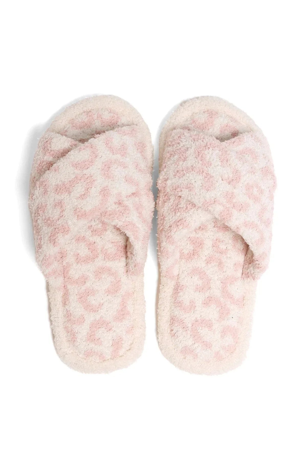 Pair of pink fuzzy slippers on a white background
