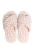 Pair of pink fuzzy slippers on a white background