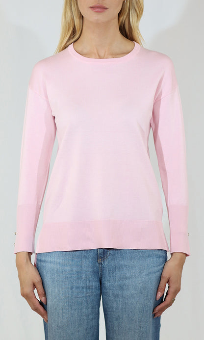 Person wearing a pink long-sleeve top and blue jeans on a white background