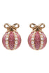 Pink glittery christmas earrings with pearl accents and gold bows on a white background