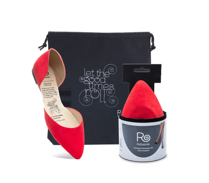 Red pointed-toe shoes with a black pouch and red shoe trees on a white background