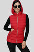 Woman wearing a red puffer vest on a gray background