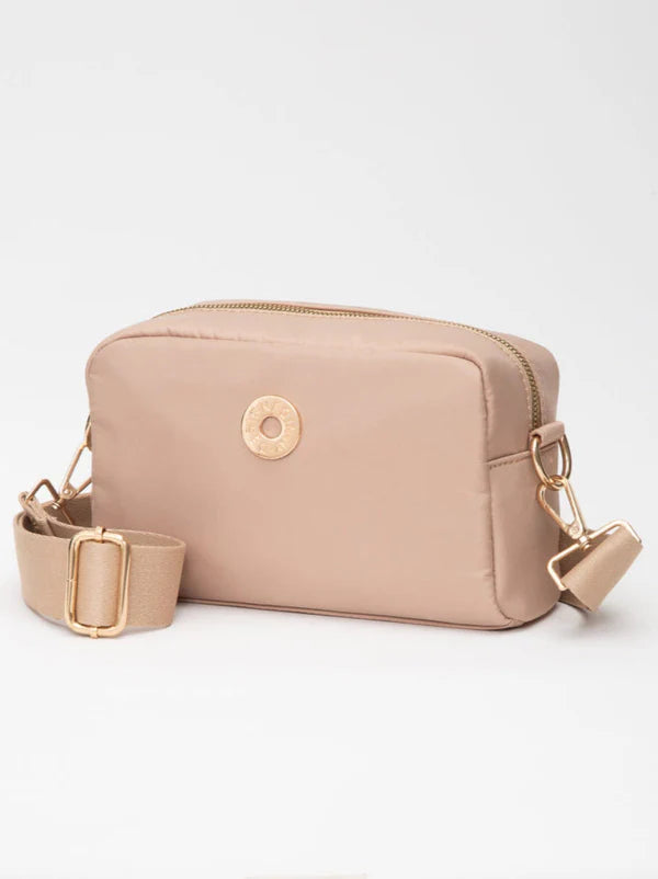 Beige crossbody bag with gold accents on a white background
