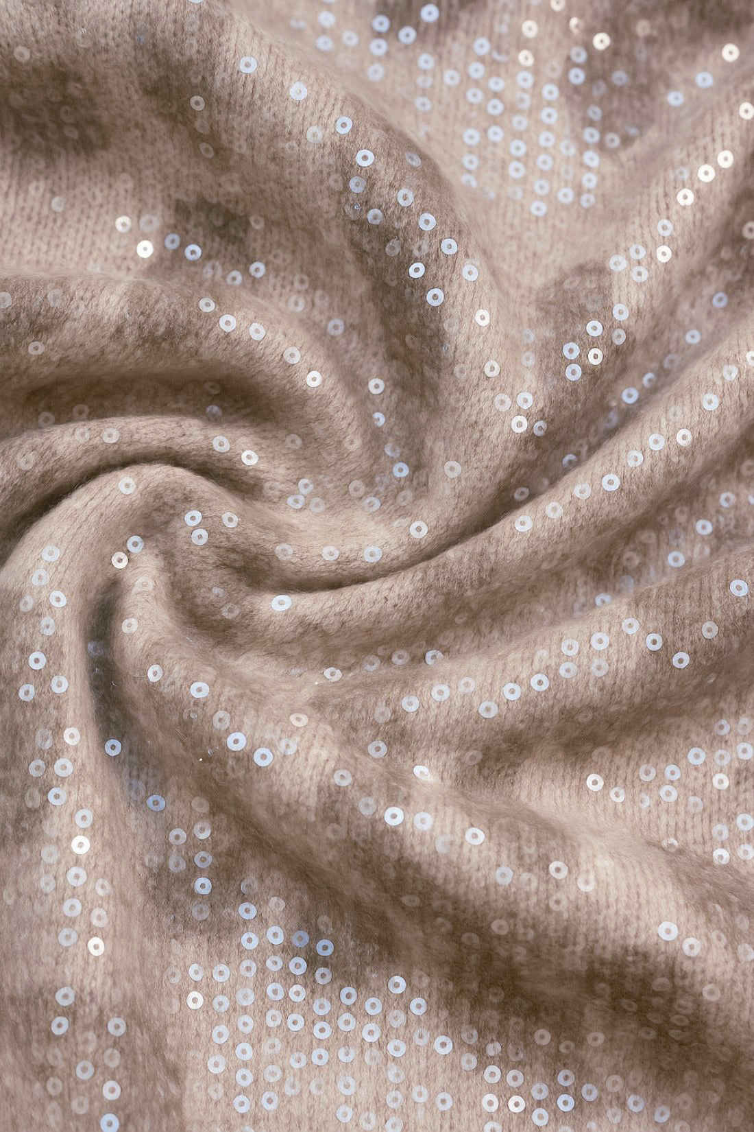 Close-up of beige fabric with silver sequins