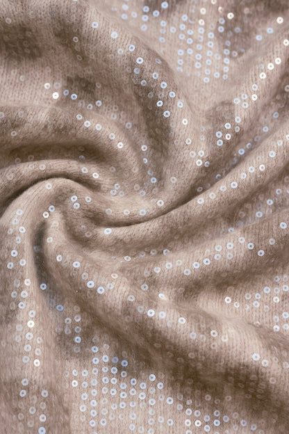 Close-up of beige fabric with silver sequins