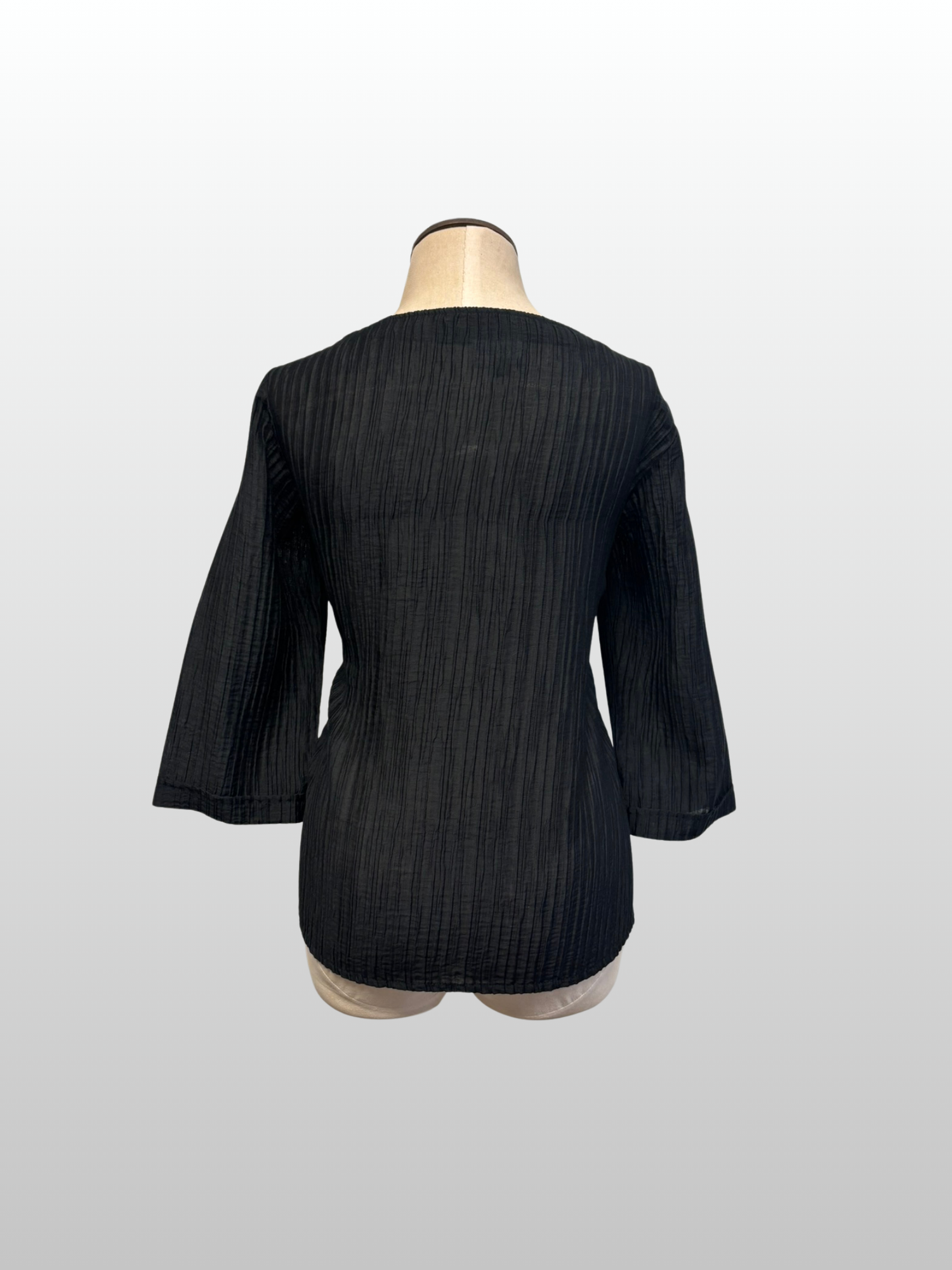 Black textured jacket on a mannequin against a white background