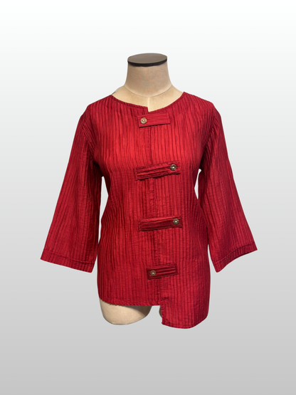 Red textured dress on a mannequin against a white background