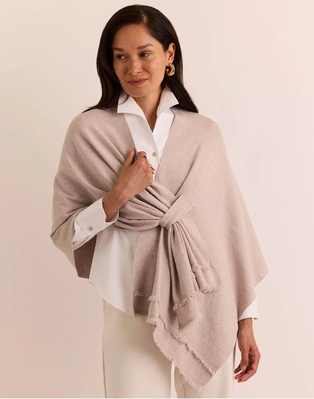 Woman wearing a beige shawl the h edition Mabel Tab Fringe Wrap stone heather