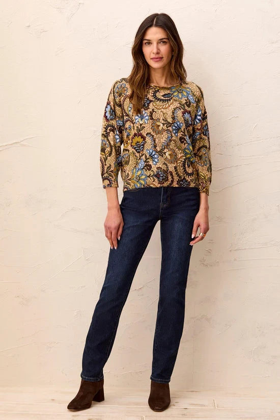 A woman wearing a long-sleeve crewneck top with an intricate paisley and floral pattern in gold, blue, green, and brown by tribal Soft Yarn Three-Quarter Sleeve Crewneck Sweater
