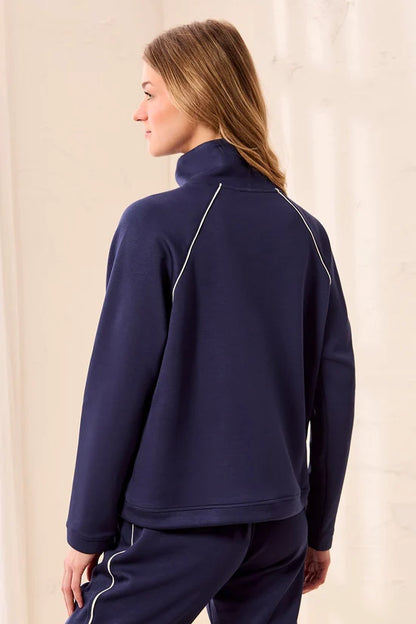 A woman wearing a navy blue quarter-zip sweatshirt with white piping details tribal TECHNO LUX Pop Over Quarter Zip Pullover