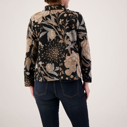 Person wearing a floral patterned jacket on a plain background