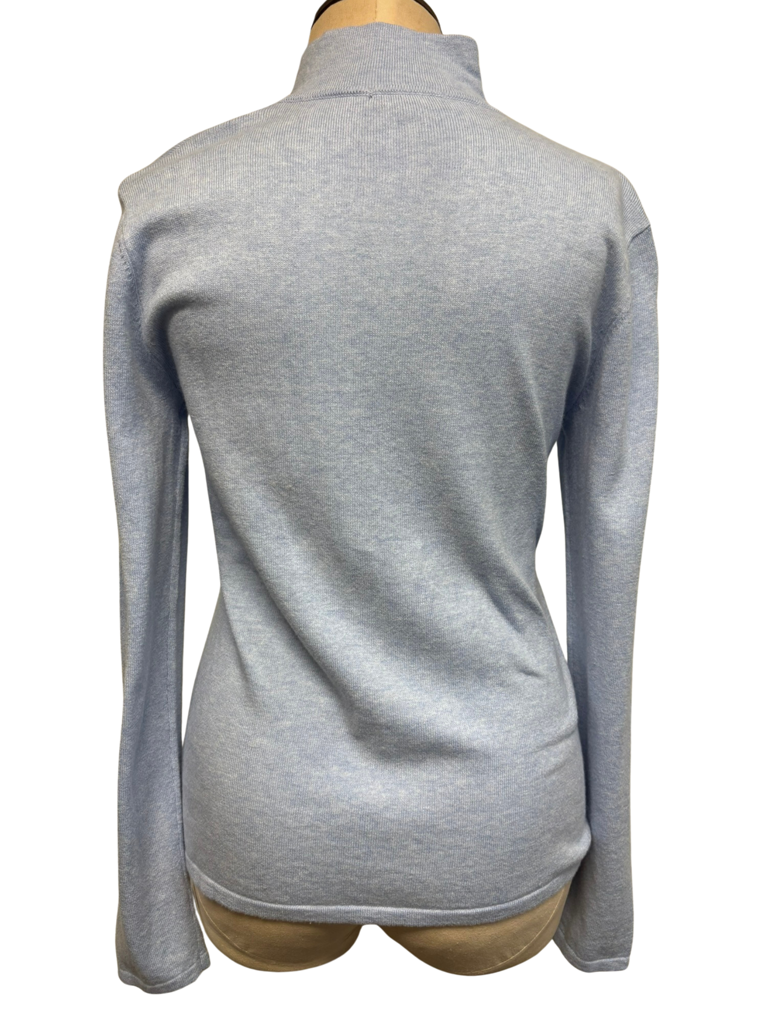 The back of a light sky blue zip-up cardigan on a mannequin against a white background