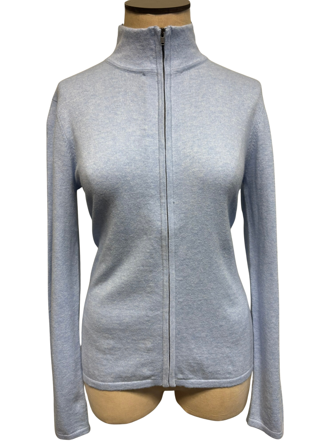 The front of a light sky blue zip-up cardigan on a mannequin against a white background